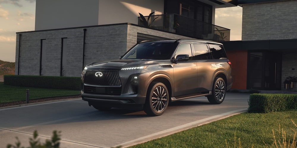 A gray 2027 INFINITI QX80 SUV in a driveway