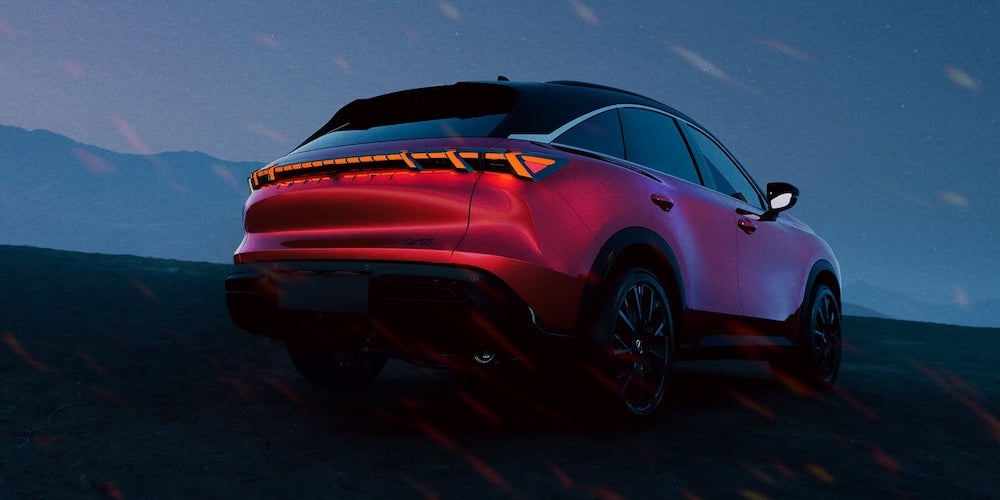 A bright red 2027 Infiniti QX65 SUV at twilight
